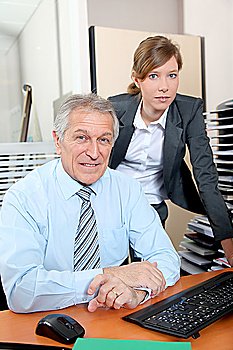 Senior businessman with young woman in the office