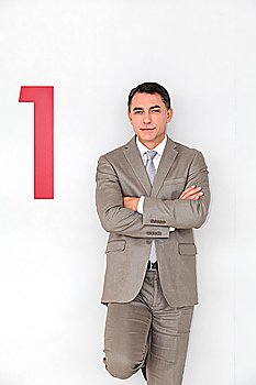 Successful businessman showing number one painted on wall