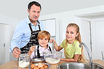 Father and children preparing pancakes