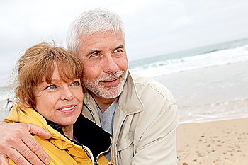 Senior couple at beach on a cloudy day