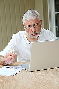 Senior man checking medical information on internet