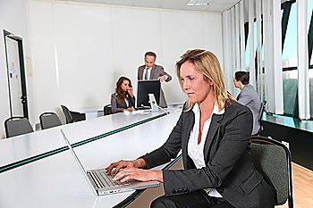 Businesswoman working in office with laptop computer