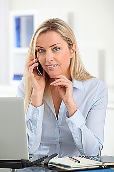 Beautiful office worker talking on the phone