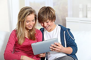 Young teenagers using electronic tablet