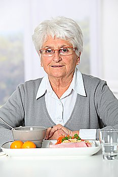 Old woman in nursing home ready to have dinner