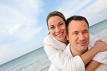 Couple relaxing in bathrobe at the beach