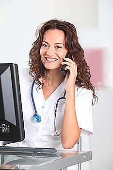 Smiling nurse in front of computer