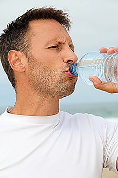 Closeup of man drinking water from bottle