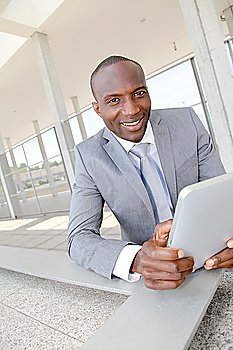 Salesman on business travel using electronic tablet