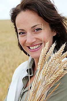 Beautiful woman standing in wheat field
