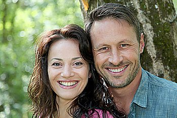 Portrait of smiling couple in forest