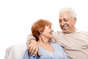 Smiling elderly pair on a white background