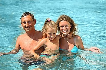 mother, father and kid swimming