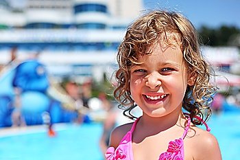 pretty little girl near pool in aquapark of an entertaining complex