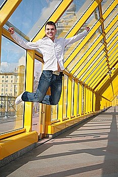 young man jumps on footbridge