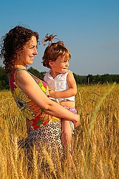 Mother with  child on  wheaten field