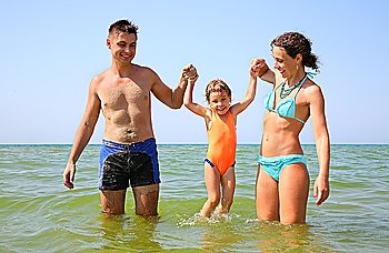 Family with little girl in sea