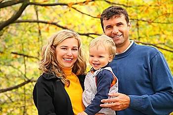 family with boy in autumn park