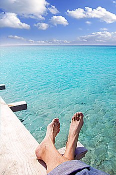 beach turquoise tourist feet relaxed on wood pier tropical sea