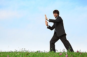 businessman pushes standing on grass