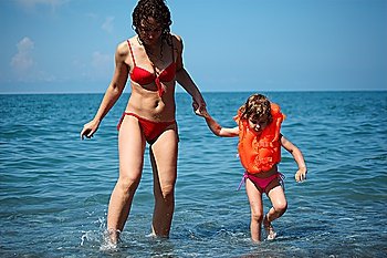Mother with daughter in sea