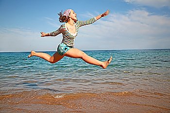 The girl in a jump about the sea