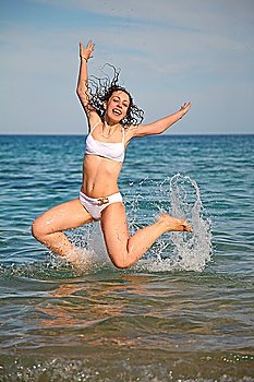 The girl jumps from the sea