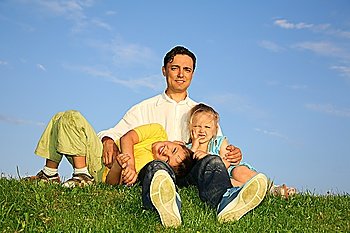 father with children on grass