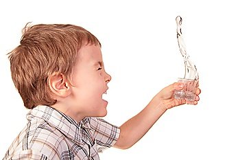 boy spills water from glass