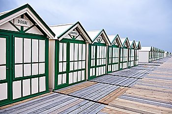 Wide angle view of wooden beach huts before rain