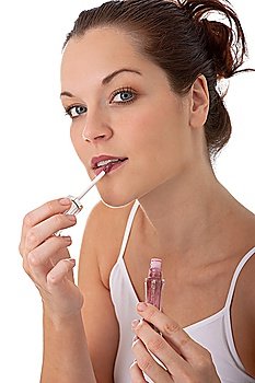 Young beautiful woman applying lipstick
