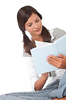 Teenager holding blue book and reading on white background