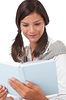 Portrait of teenager reading book on white background