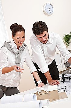 Young man and woman working together at the office