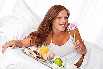 Young woman having breakfast in luxury hotel room
