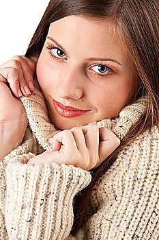 Portrait of beautiful young woman wearing turtleneck on white background