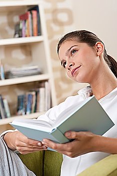 Students - Female teenager reading book in modern living room