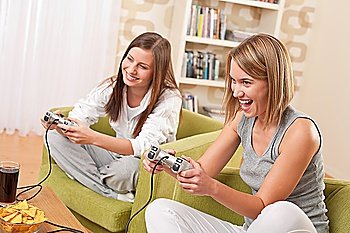 Students - Two happy female teenager playing TV game and having fun