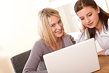Two girls sitting at laptop