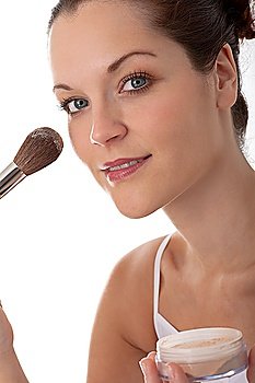 Young beautiful woman with make-up brush