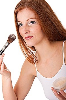 Beautiful red hair woman applying powder on white background