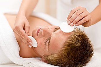 Male cosmetics - cleaning face treatment at luxury spa
