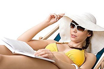 Beach - Attractive woman in bikini sunbathing on deckchair with hat, book and sunglasses