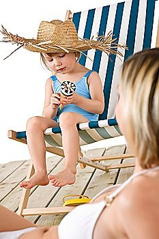 Beach - Mother with child on deck-chair eating ice-cream cone
