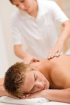 Man having luxury back massage in spa center