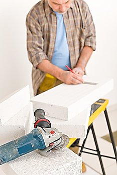 Home improvement - handyman measure porous brick in workshop