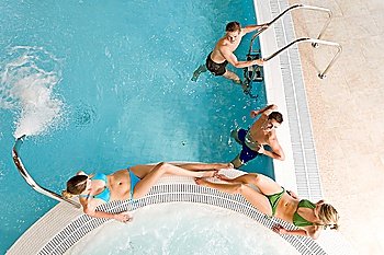 Top view - young people relax in swimming pool at bubble bath