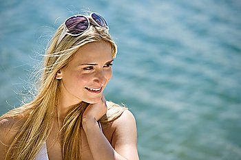 Blond woman with sunglasses at sea