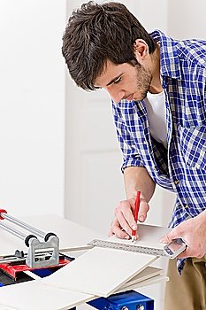 Home improvement - handyman cut ceramic tile in workshop