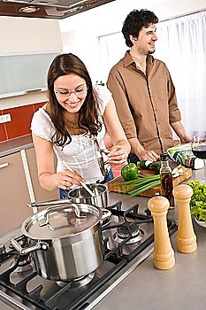 Young couple cooking together in modern kitchen together